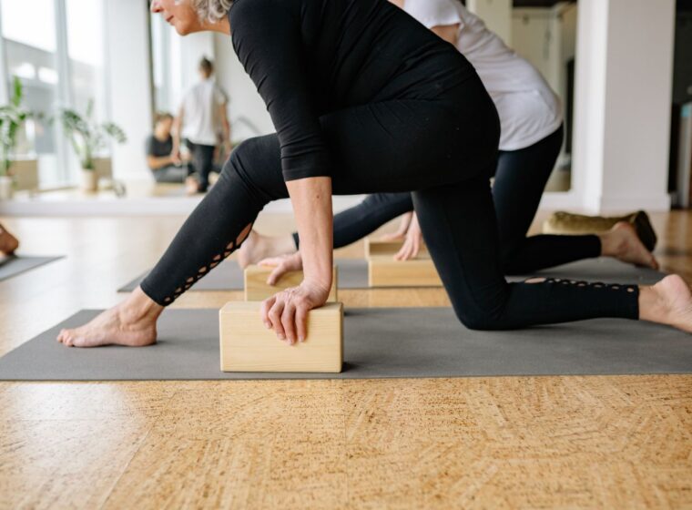 Participantes en una clase de yoga utilizando bloques de apoyo